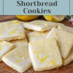 A stack of lemon shortbread cookies, enhanced with a tantalizing glaze and sprinkled with fresh lemon zest, sits elegantly on a wooden board. A text overlay joyfully invites you to "Learn How to Make Lemon Shortbread Cookies.