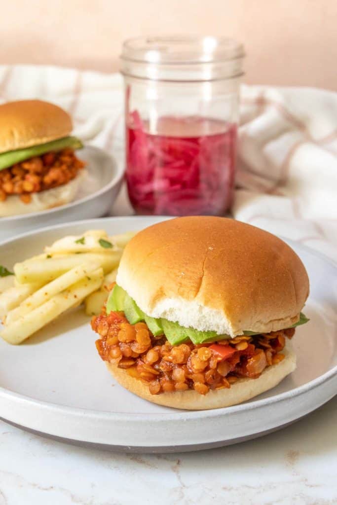 A plate with lentil sloppy joe and jicama salad.