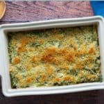 A rectangular casserole dish showcases a delectable asparagus casserole with a golden breadcrumb topping. The text reads "Asparagus Casserole" and proudly exclaims "homemade recipe.