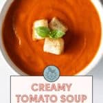 A bowl of creamy tomato soup topped with croutons and basil, labeled "Creamy Tomato Soup, Panera Tomato Soup Copycat Recipe. Get the recipe at stetted.com.