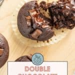 Indulge in these double chocolate muffins, showcased on a rustic wooden surface. One muffin is split open, revealing its irresistibly gooey interior. A tempting label invites you to "Get the recipe at stetted.com" and savor every bite.