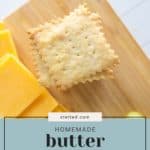 A close-up of stacked homemade butter crackers on a wooden board next to squares of cheese and green grapes. The text "stetted.com Homemade butter crackers" is overlaid on the image.