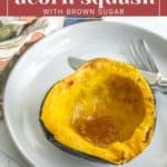 A halved roasted acorn squash with browned edges, served on a white plate with a fork, featuring a topping of brown sugar. Text above the image reads, "roasted acorn squash with brown sugar.