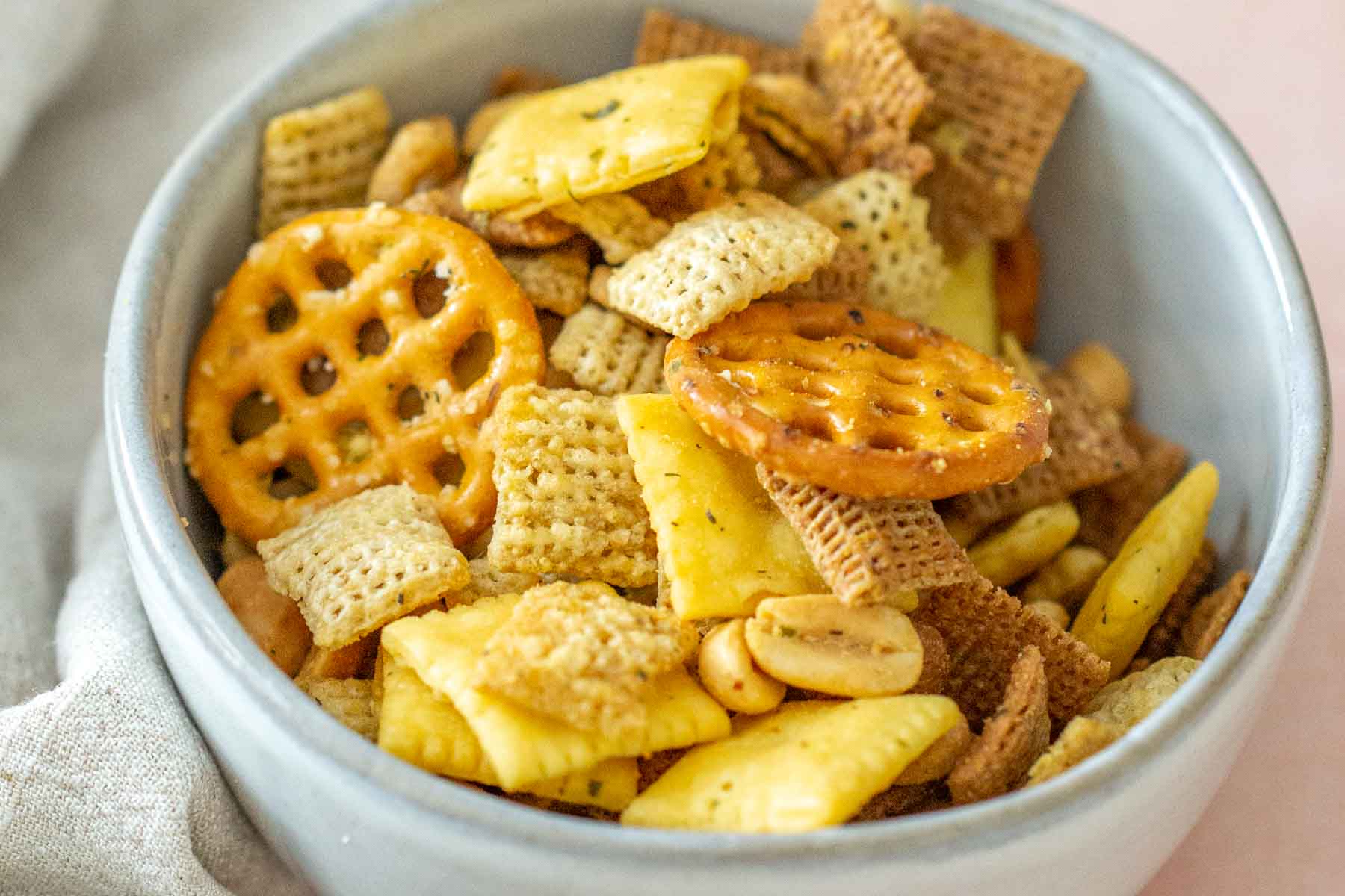 Close up of buffalo flavored chex mix in a bowl.