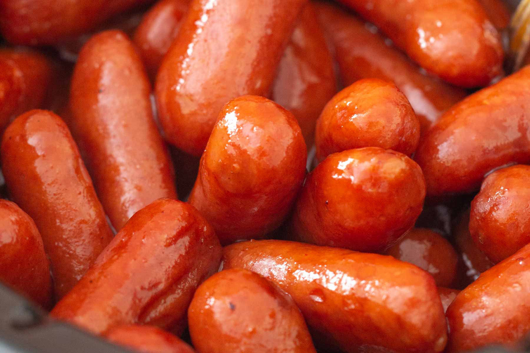 Close up of mini smoked sausages in a slow cooker.