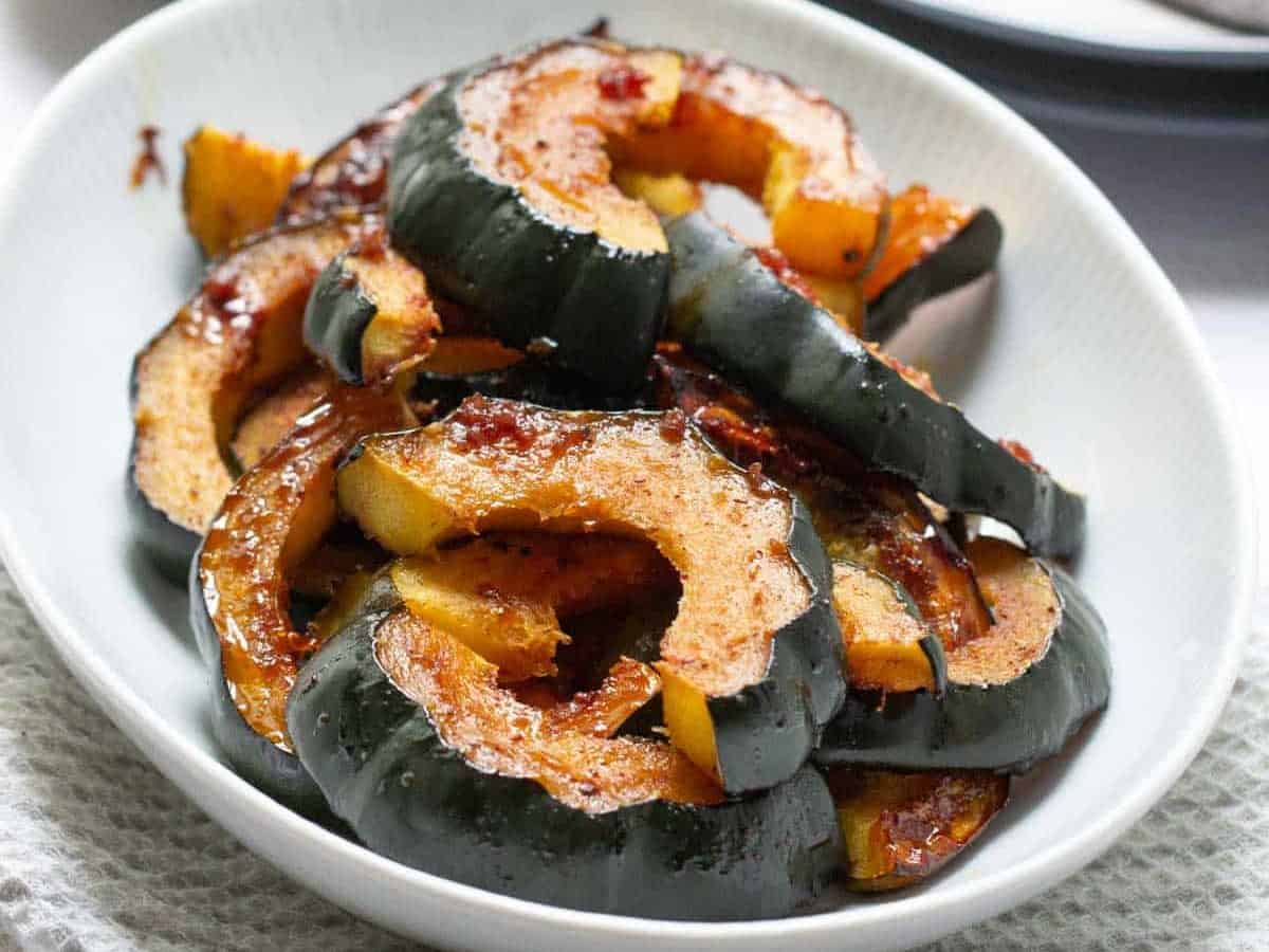 glazed acorn squash in a serving dish