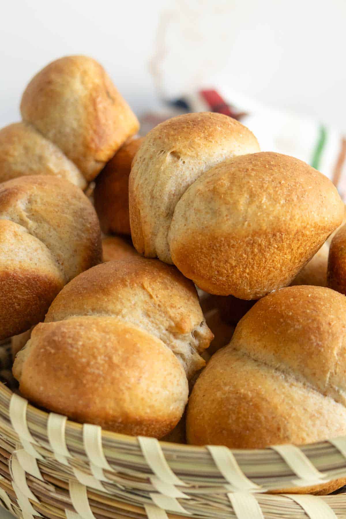 A basket filled with freshly baked, golden-brown bread rolls.