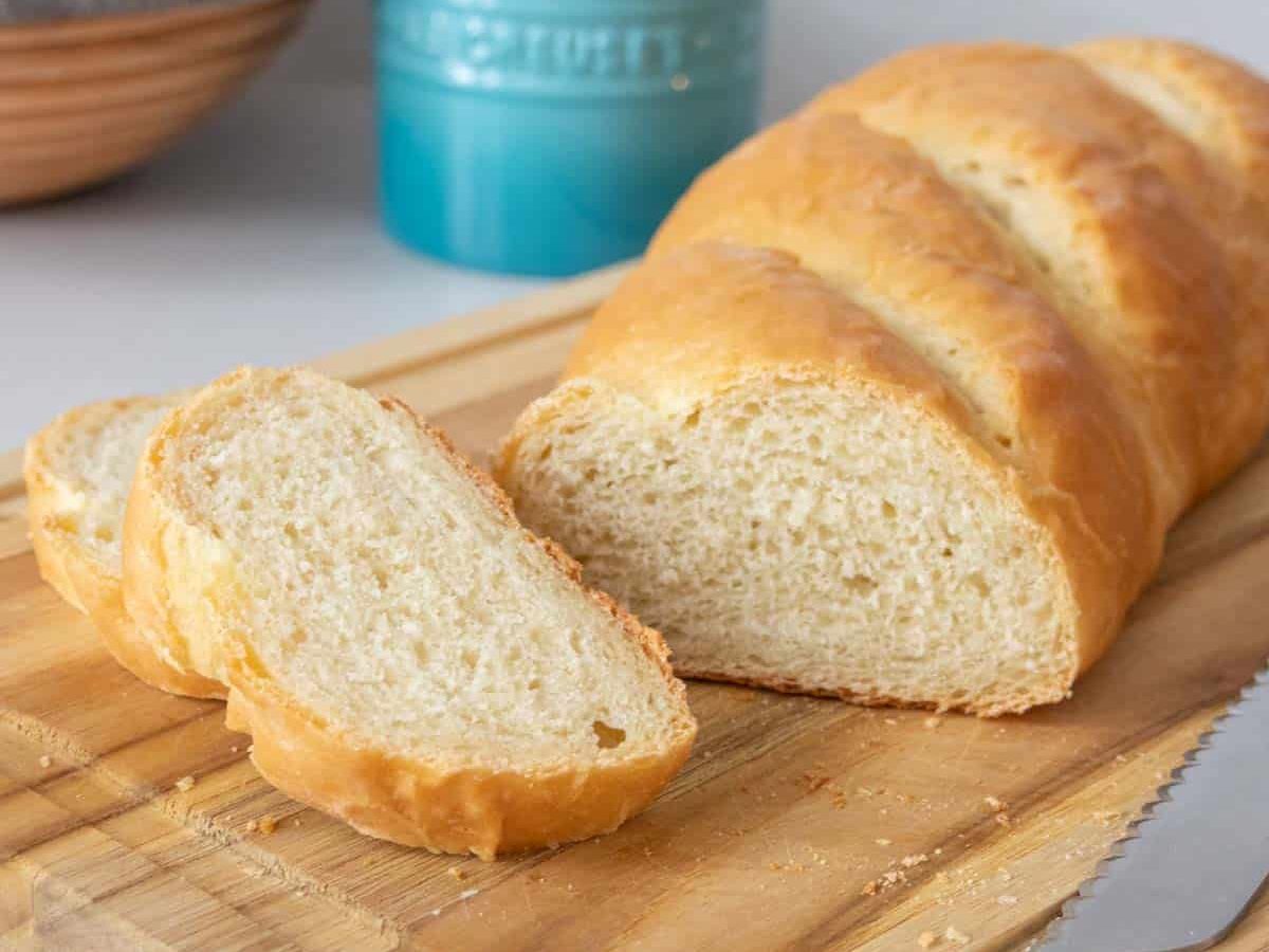 Sliced French bread on a cutting board.