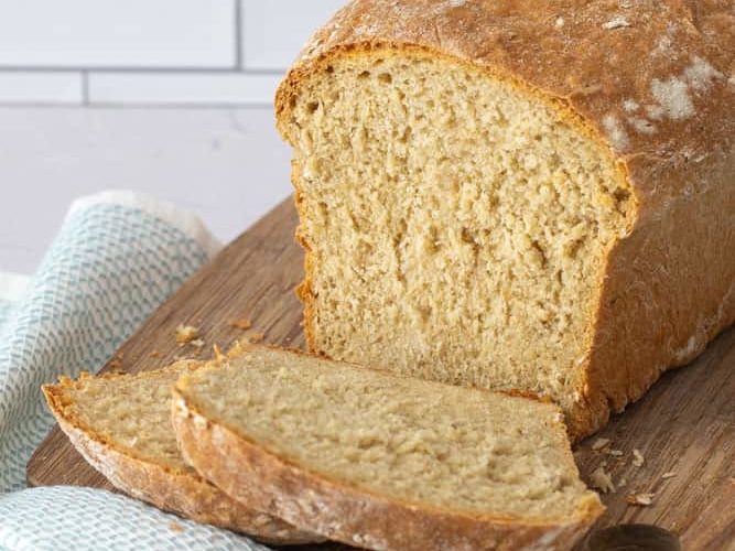 sliced honey oatmeal bread on a cutting board