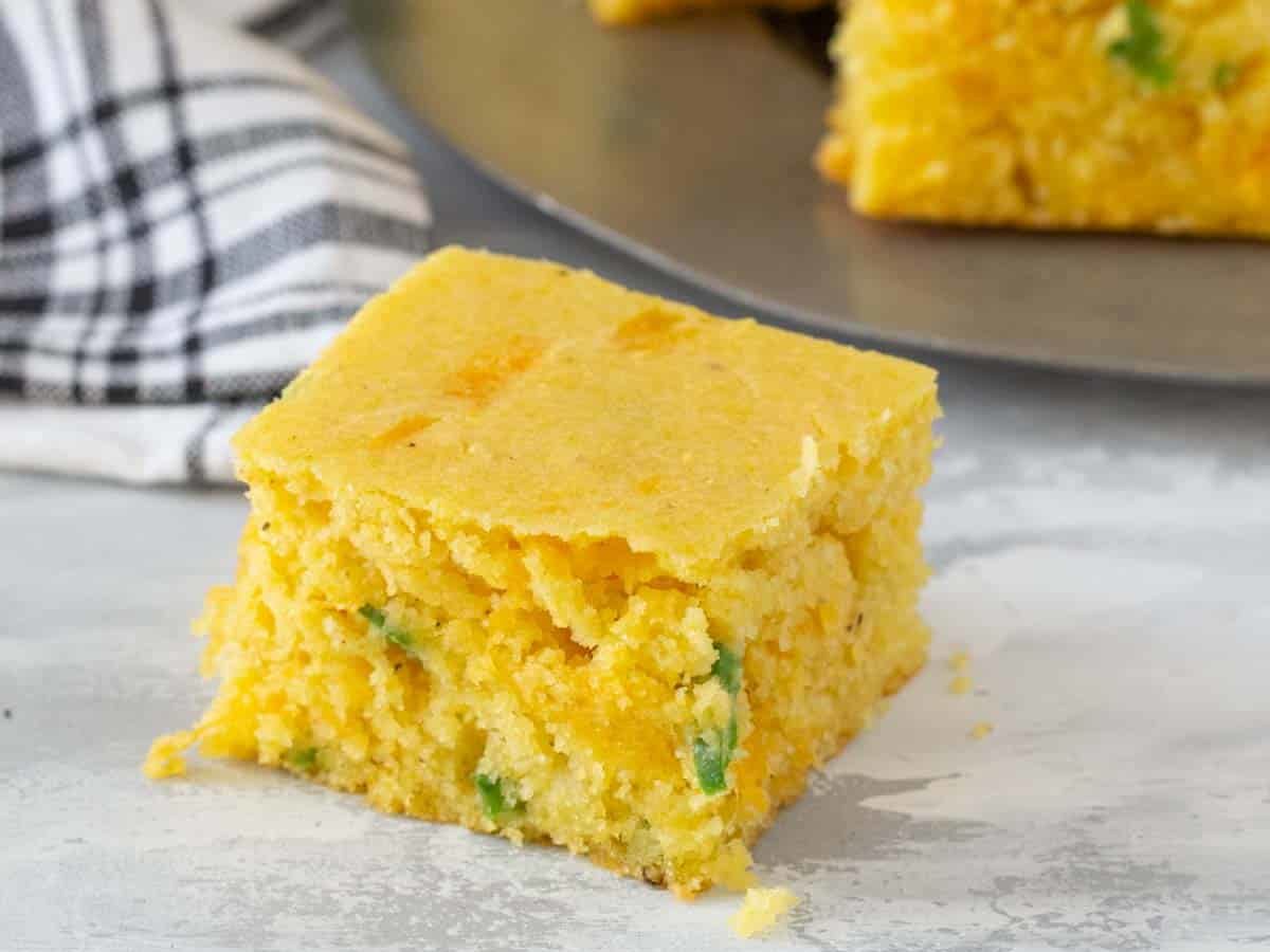 square of jalapeno cornbread on gray surface