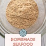 A jar filled with homemade seafood seasoning; text below reads "Homemade Seafood Seasoning - Get the recipe at stetted.com".