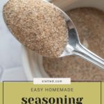 A close-up of a spoon holding seasoning salt blend over a white bowl. Text reads "Easy Homemade Seasoning Salt Blend.