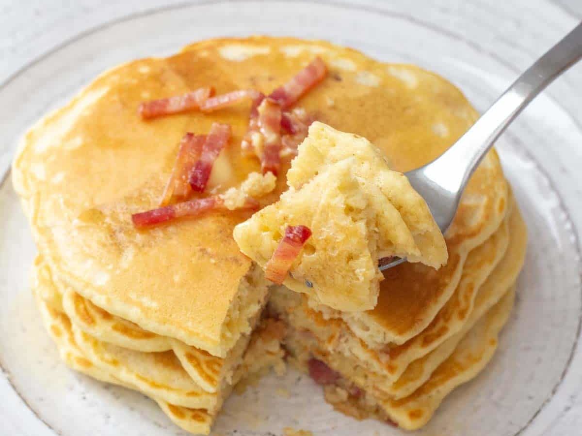 fork holding pieces of bacon pancakes