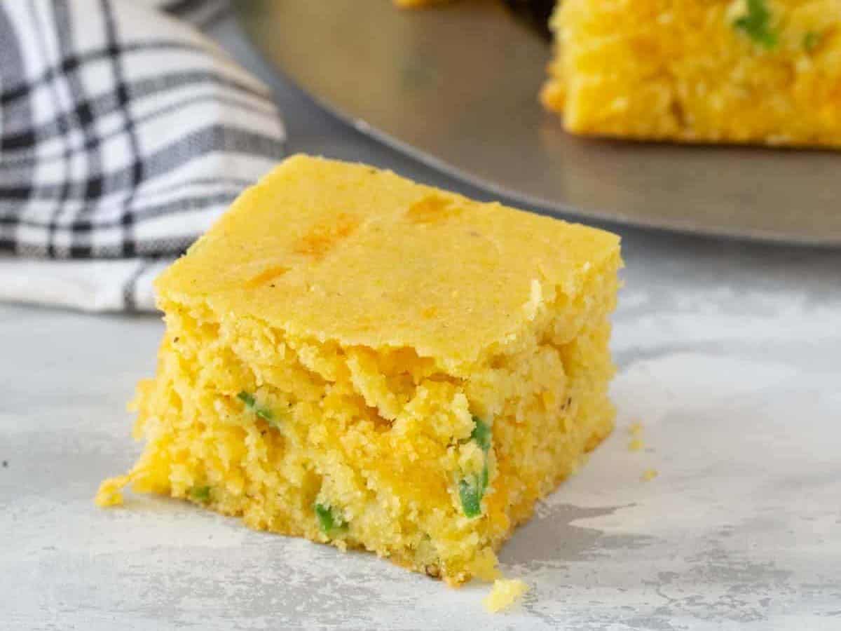 square of jalapeno cornbread on gray surface