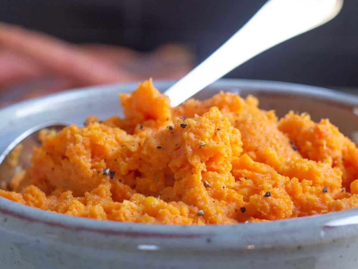 mashed carrots in gray bowl