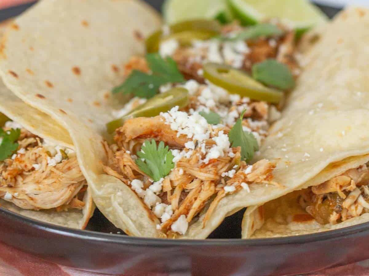 slow cooker shredded chicken tacos with cheese and jalapenos