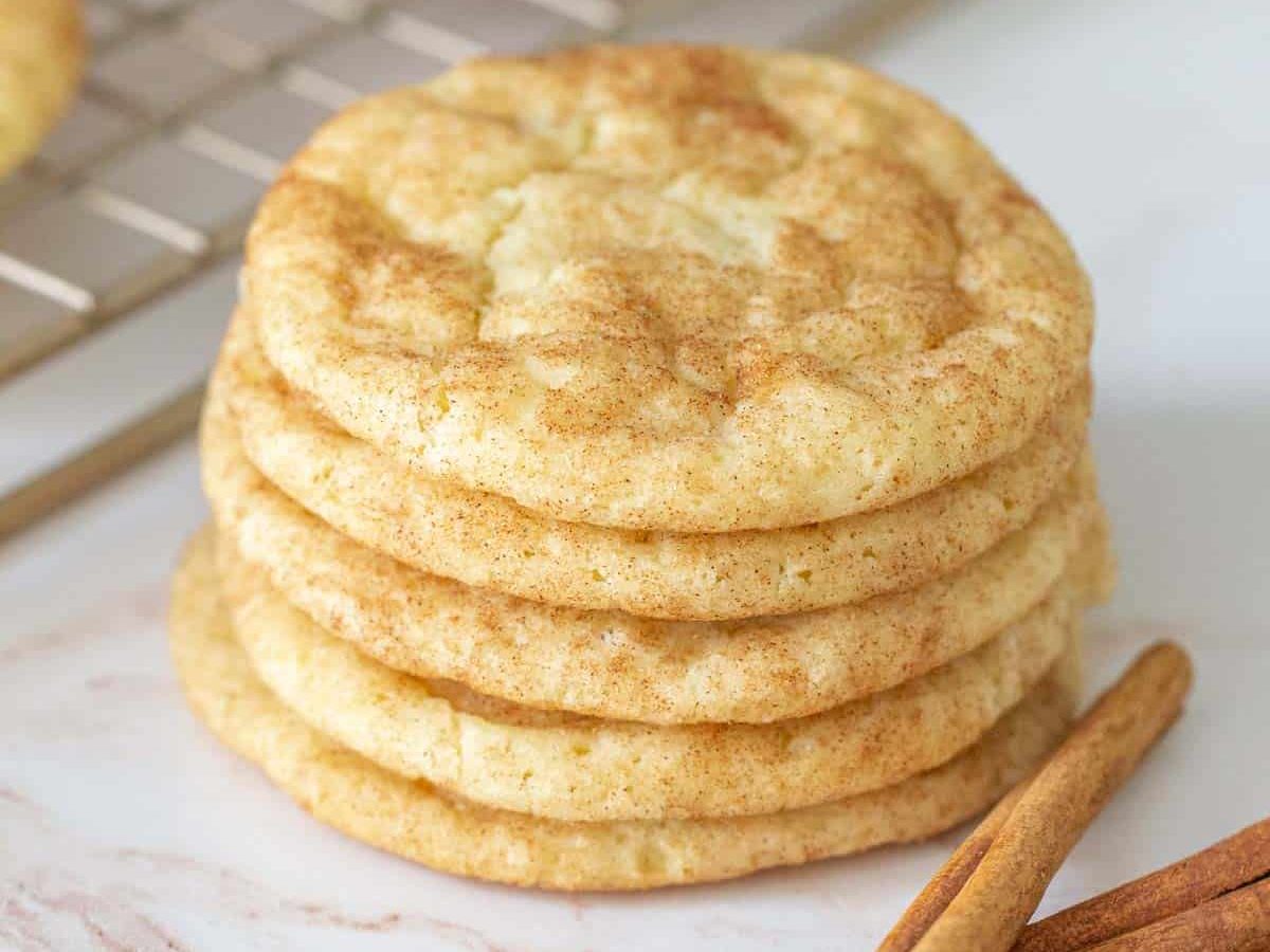 stack of snickerdoodle cookies with cinnamon sticks