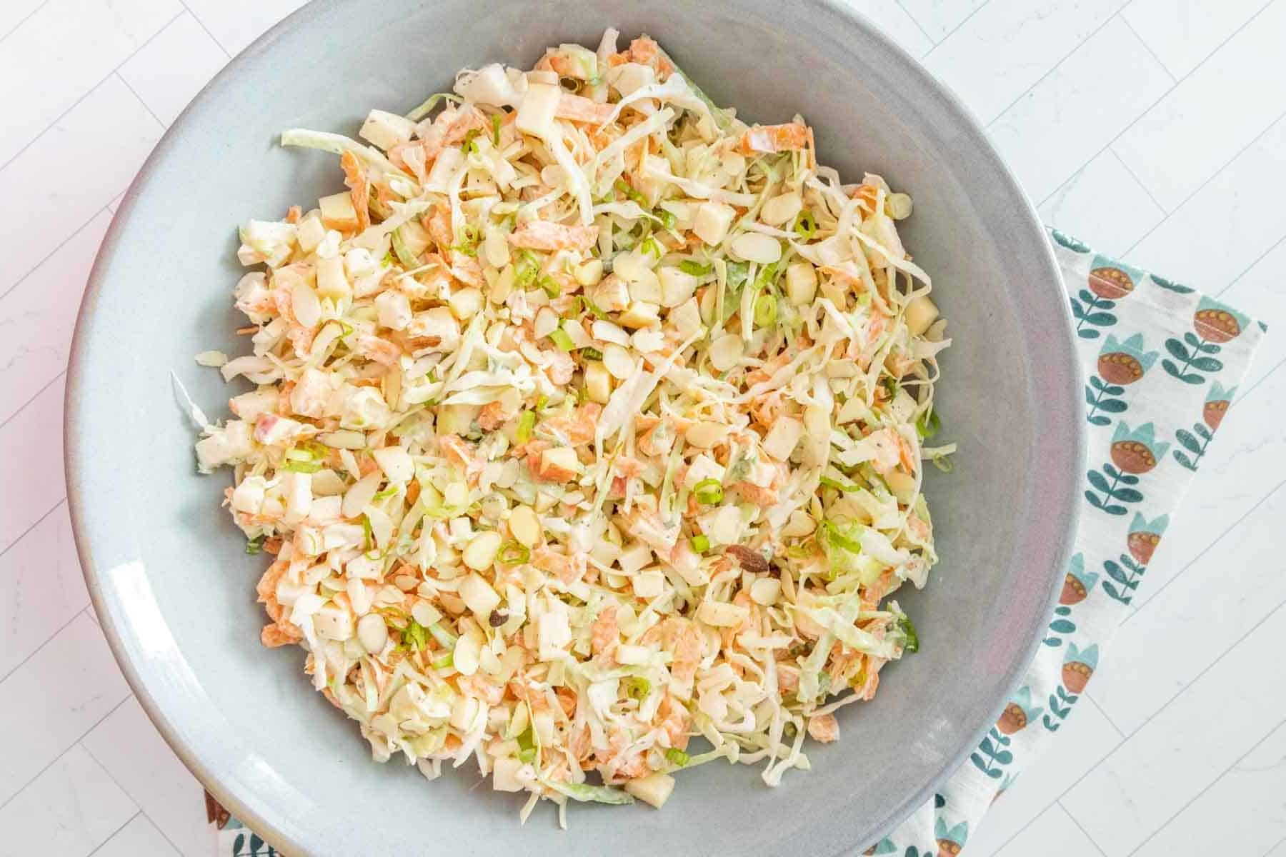 A bowl of slaw with carrots and celery.