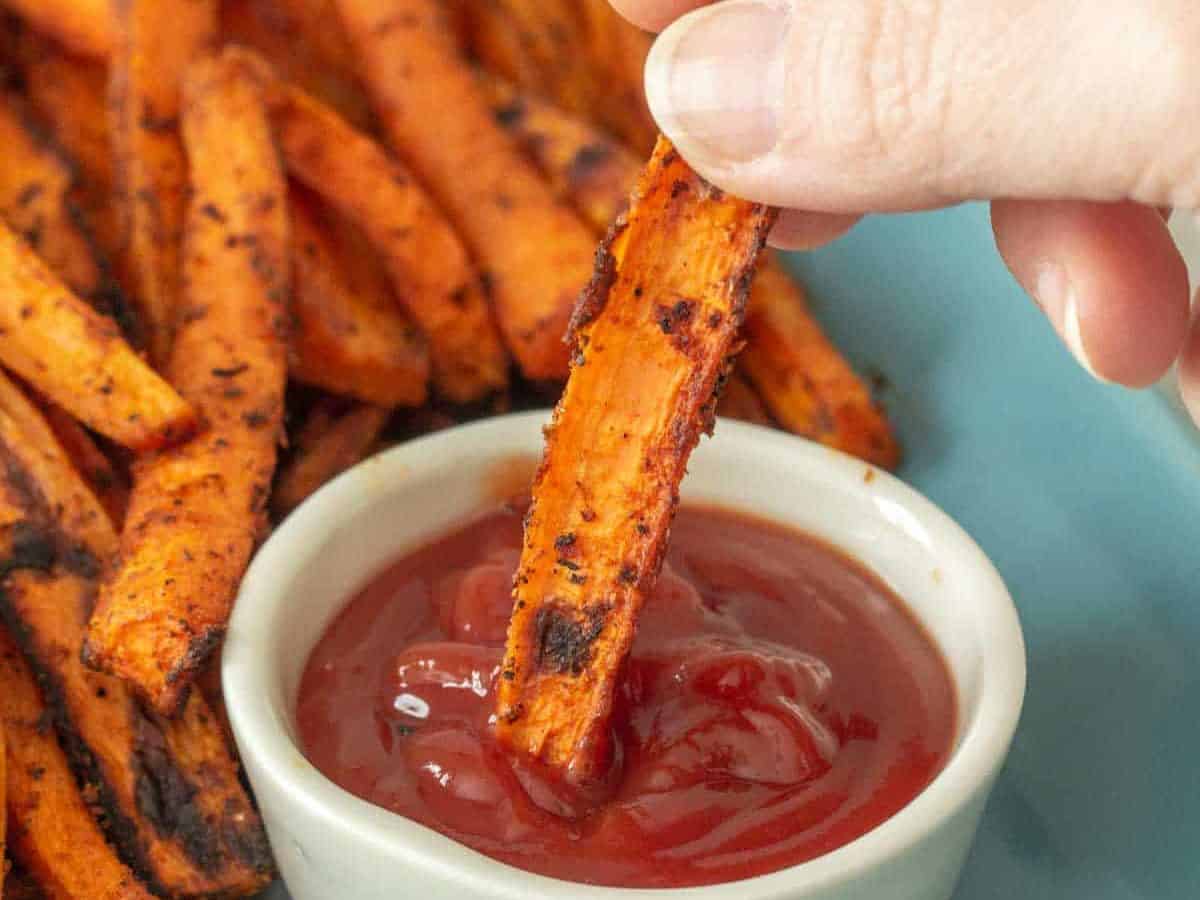 carrot fries dipping into ketchup