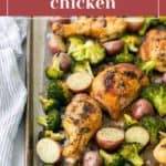 Roasted chicken legs with broccoli and potatoes on a sheet pan.