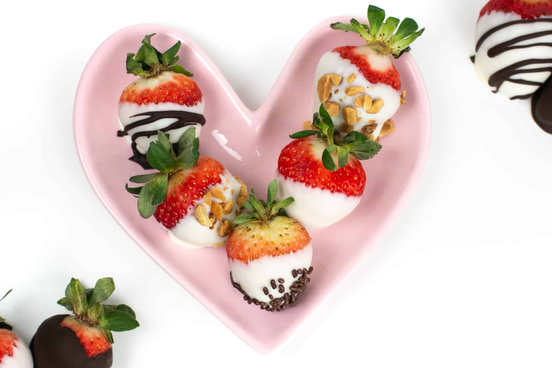 A heart plate with chocolate covered strawberries.