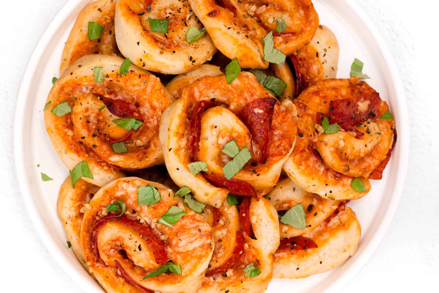 A plate of pizza pinwheels.